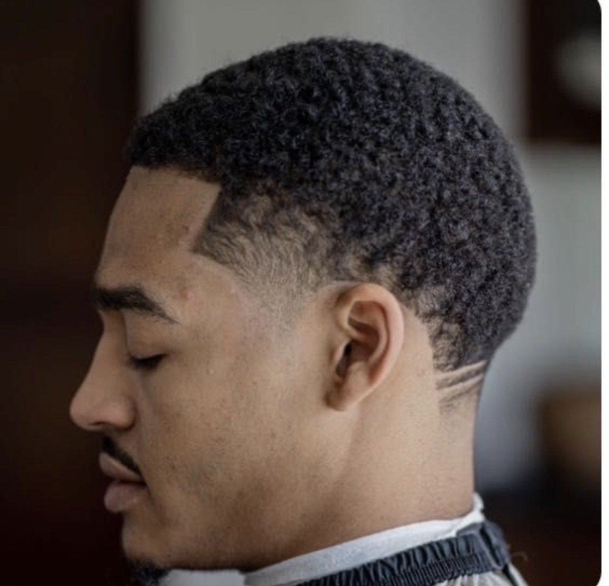 Curly top with a tapered fade