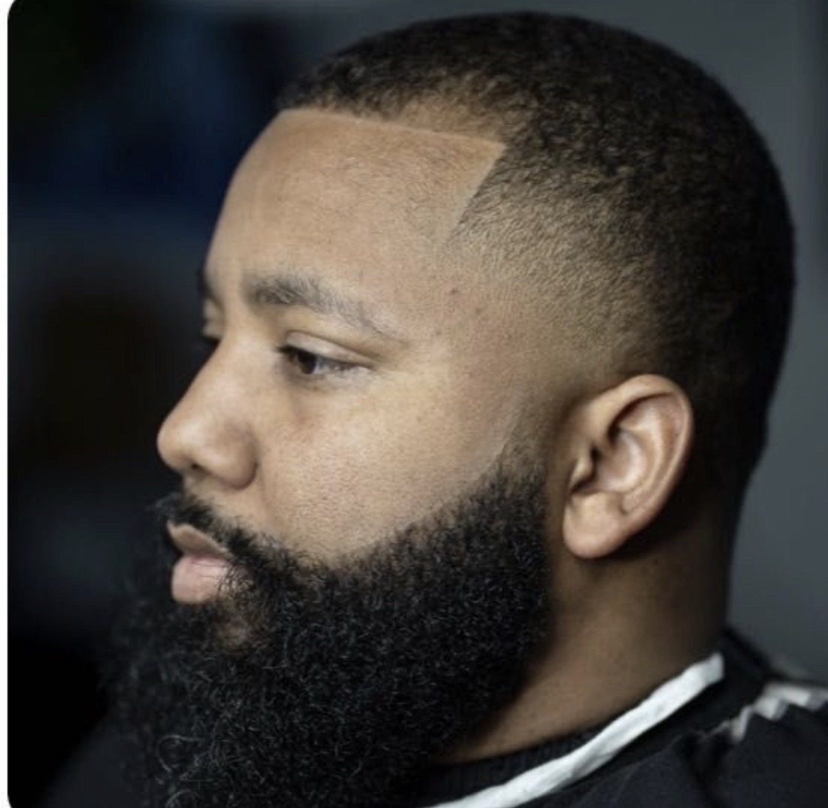 Low fade with a full sculpted beard
